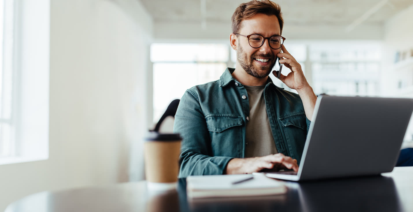 Property management firm owner taking an evening call at his laptop